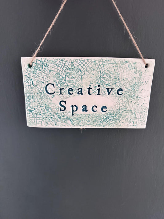 Creative Space. Hanging ceramic sign